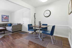 Dining room with dark wood finished floors and baseboards