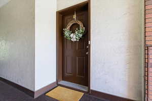 Entrance to property featuring stucco siding