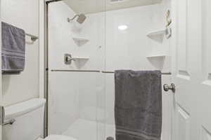 Full bathroom with a marble finish shower