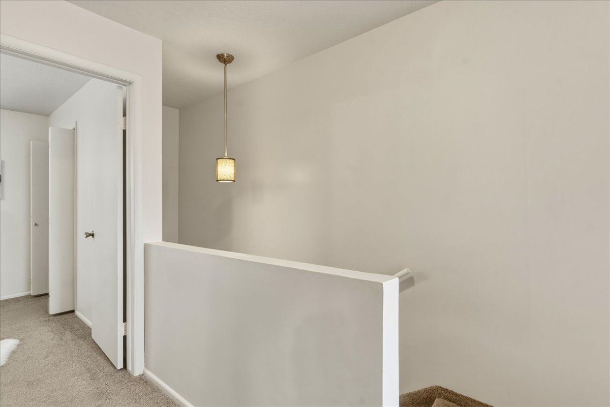 Hall with an upstairs landing and carpet floors