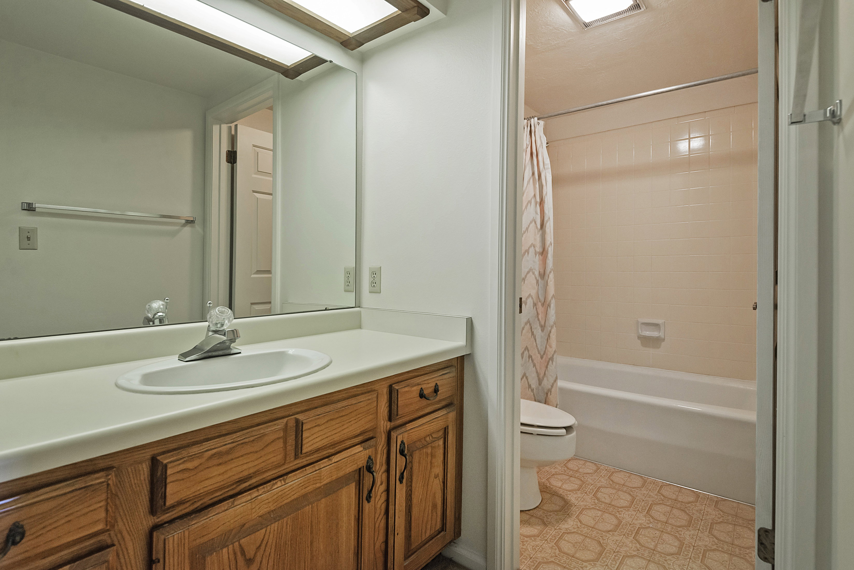 Bathroom featuring vanity and shower / bath combo