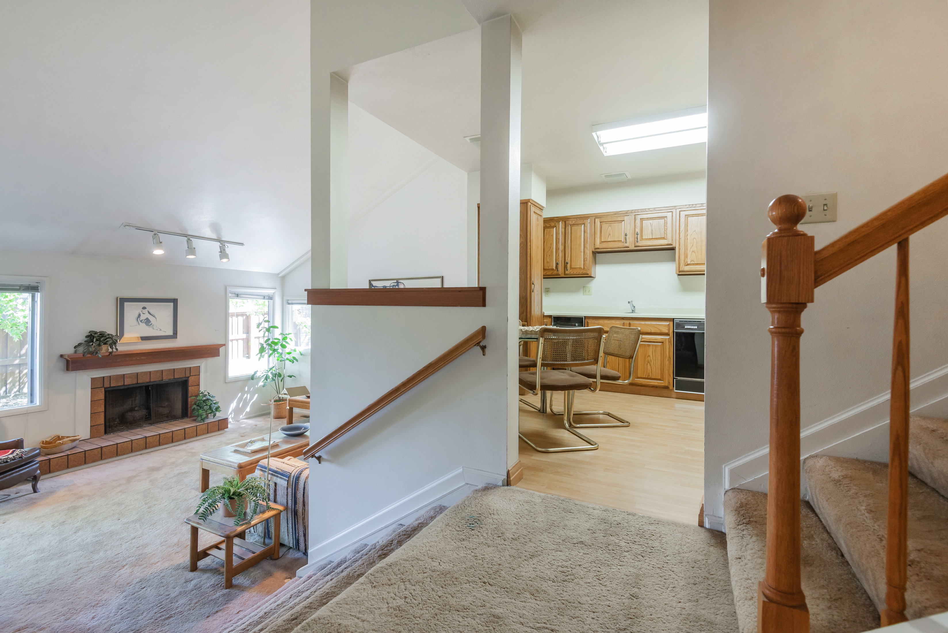 Living room with a tile fireplace and track lighting