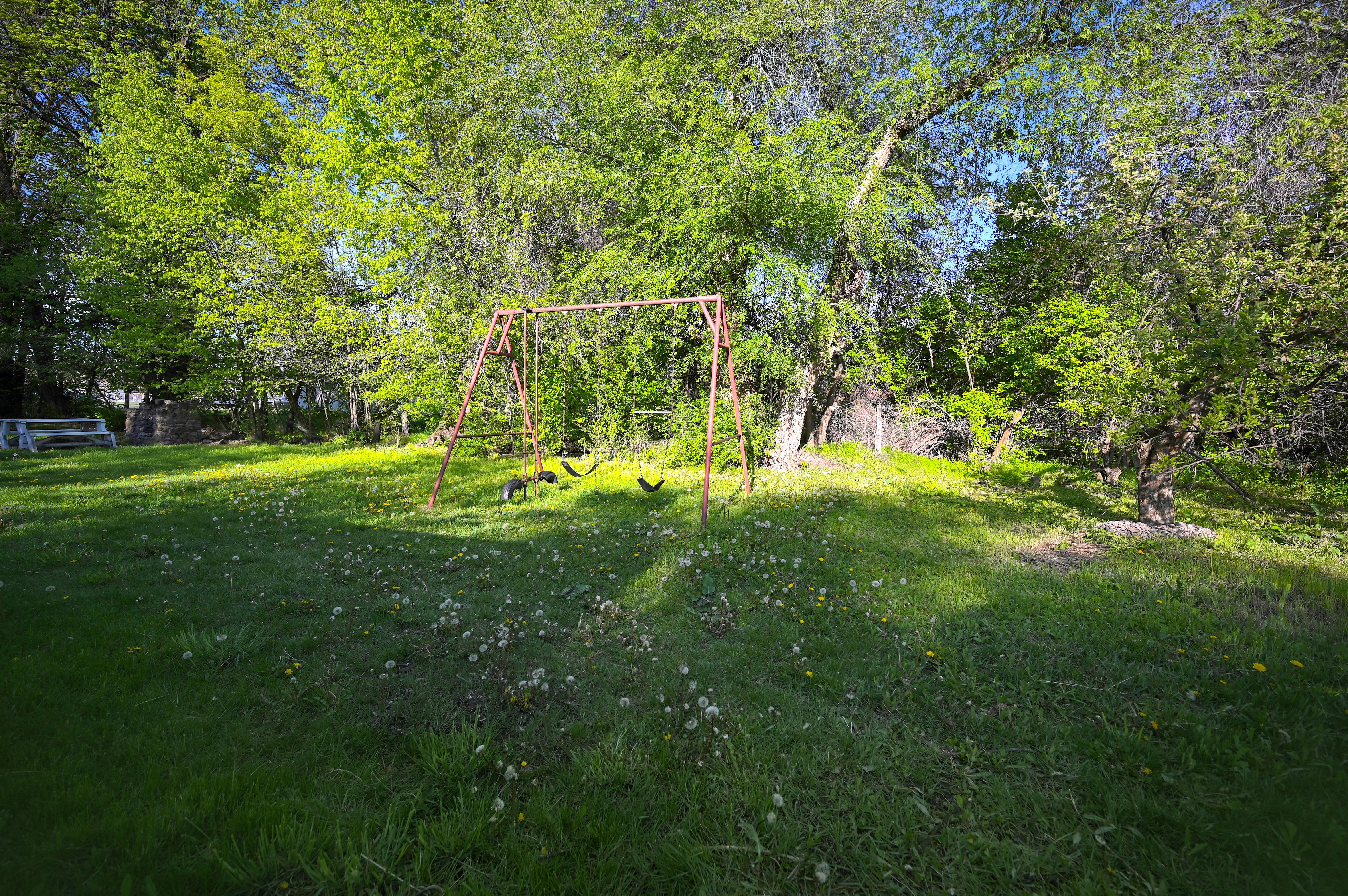 View of grassy yard featuring a playground