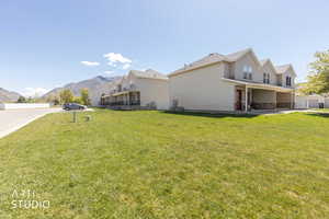 View of side of home featuring a mountain view, a patio, and stone siding