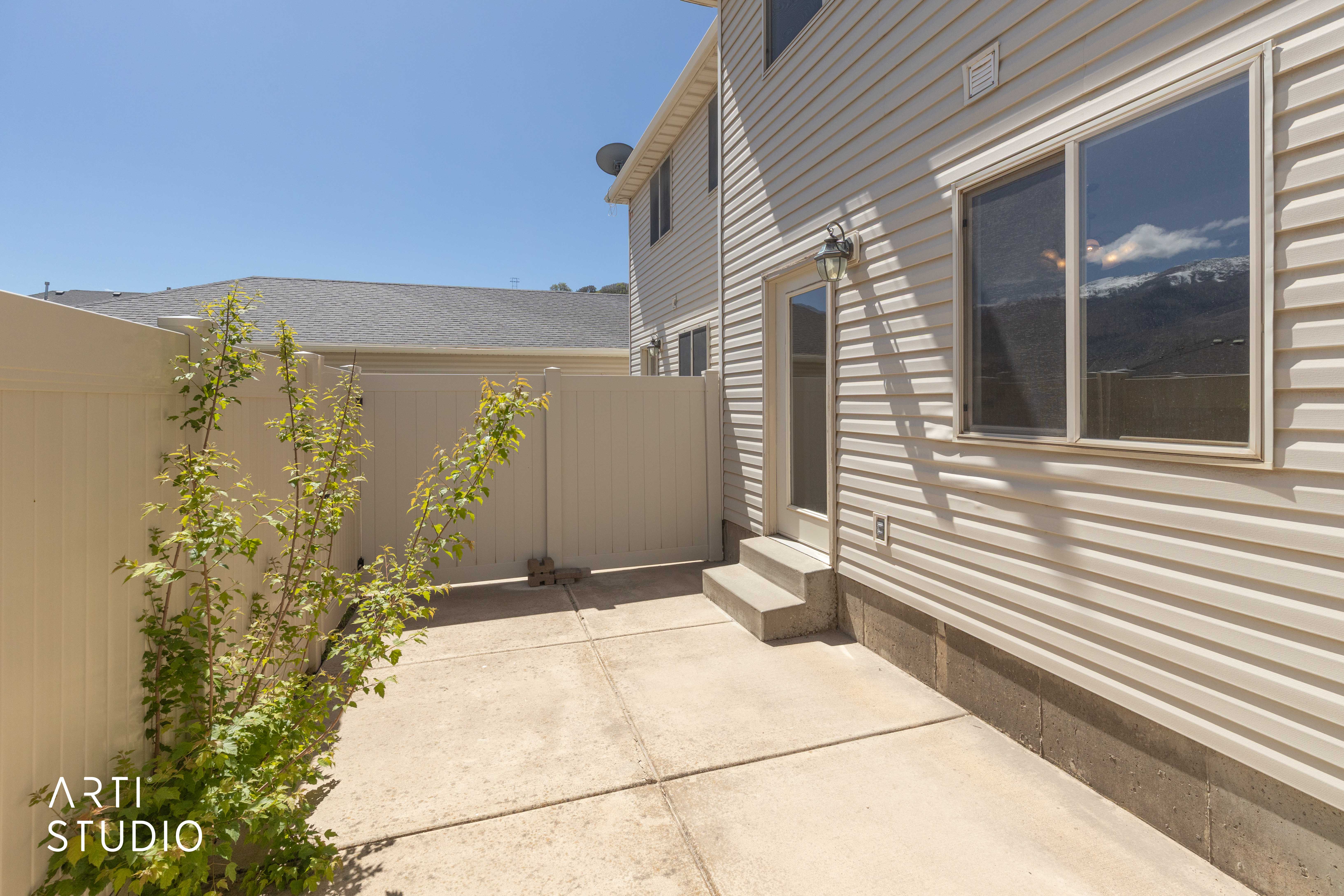View of property exterior and patio featuring entry steps