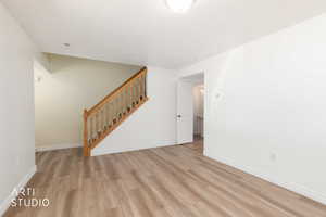 Living room featuring stairway and light wood finished floors