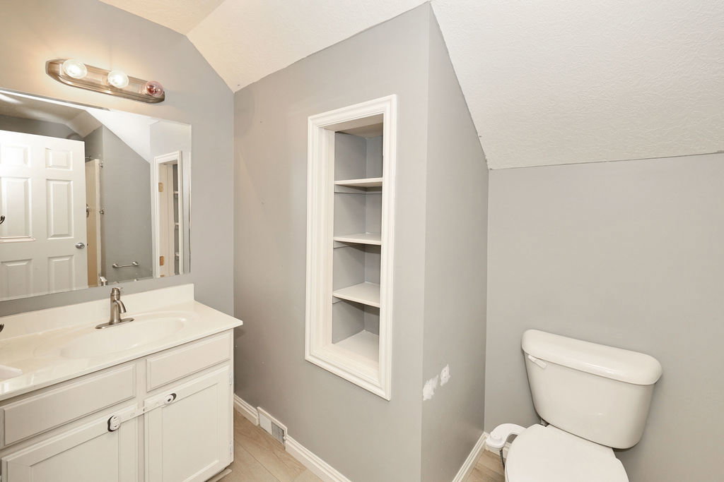 Half bathroom featuring vanity and built in shelves