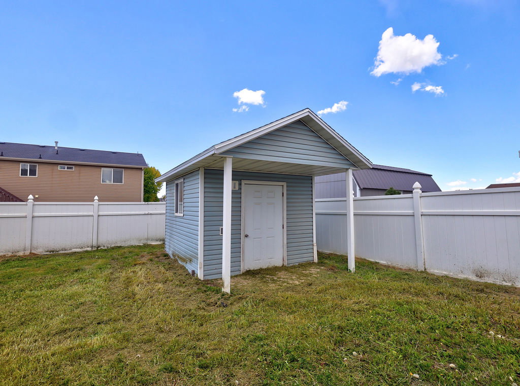View of shed with a fenced backyard