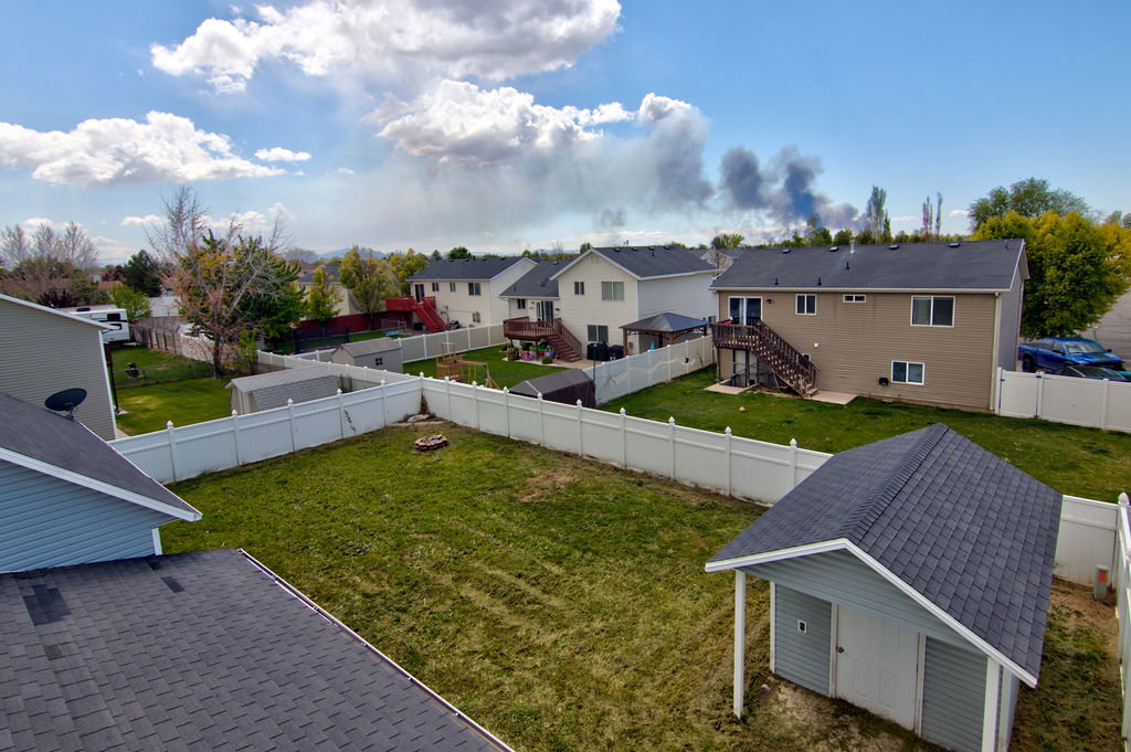 Fenced backyard with a residential view and stairway