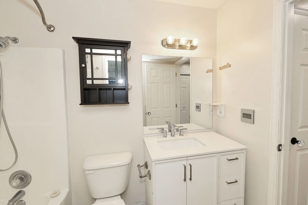 Bathroom with vanity and shower / tub combination