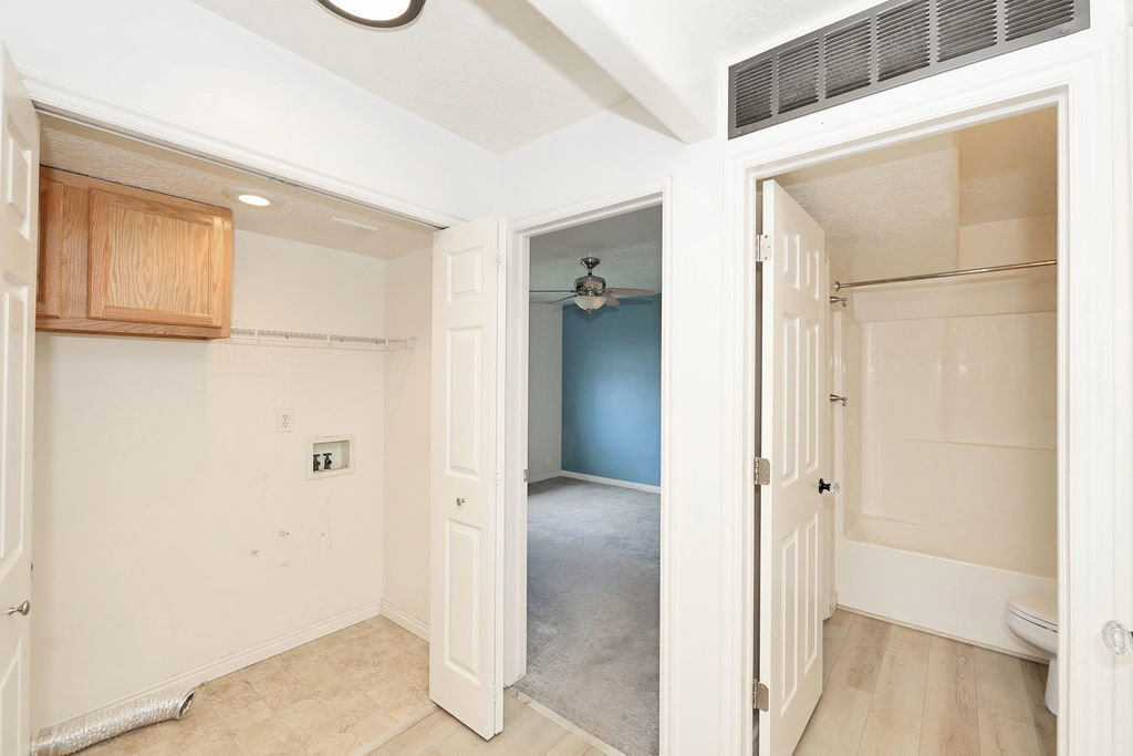 Laundry area with hookup for a washing machine, a ceiling fan, recessed lighting, and cabinet space