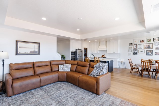 Open-concept living space featuring wood-finish flooring and recessed lighting