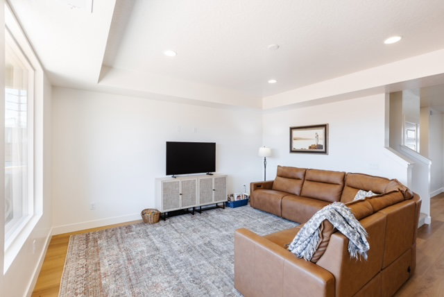 Bright living space featuring recessed lighting, light wood-finish flooring, and white walls