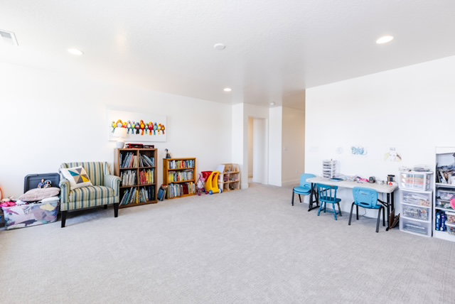 Spacious room with light-toned carpet flooring and recessed ceiling lighting