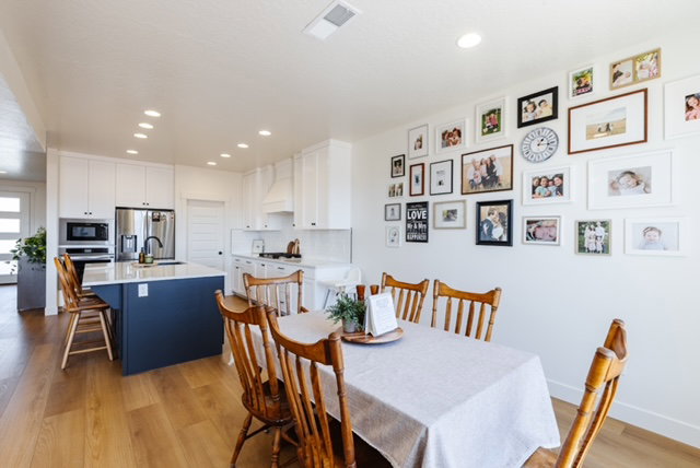 Open-concept kitchen and dining area featuring wood-finish flooring
