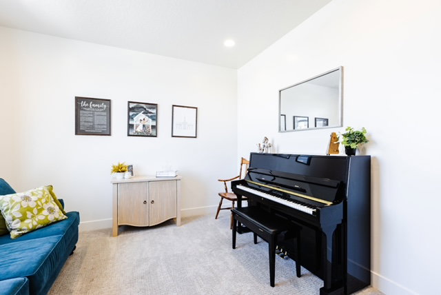 Bright interior space featuring light gray carpet, white painted walls, and recessed lighting