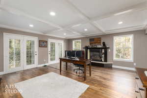 Office area featuring dark wood-style floors, recessed lighting, a glass covered fireplace, and coffered ceiling