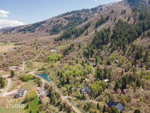 Aerial overview of property's location featuring a large body of water and a heavily wooded area