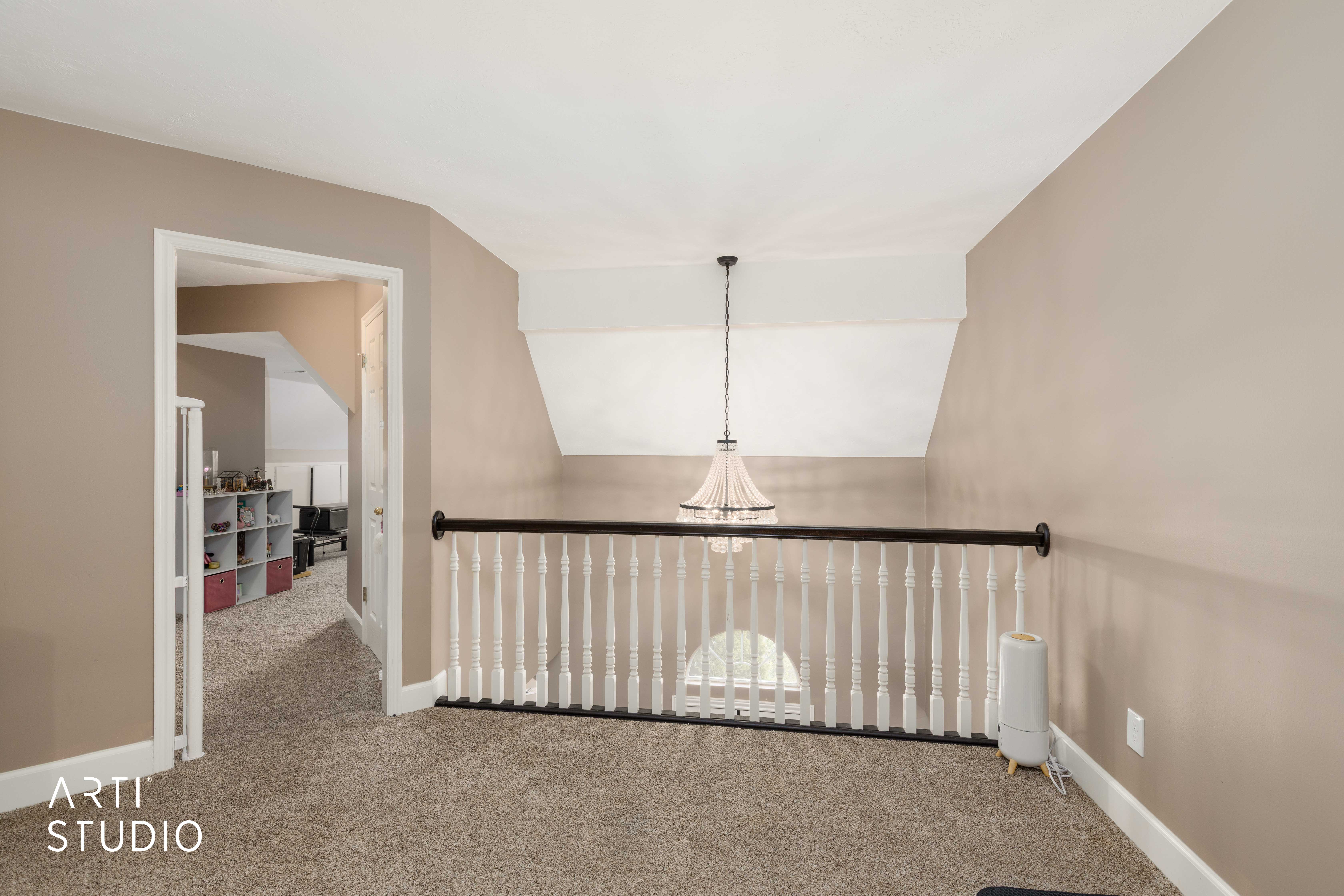 Corridor with carpet flooring and lofted ceiling
