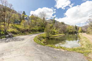 View of asphalt street with a water and mountain view