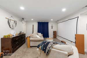 Home theater with crown molding, light carpet, and recessed lighting