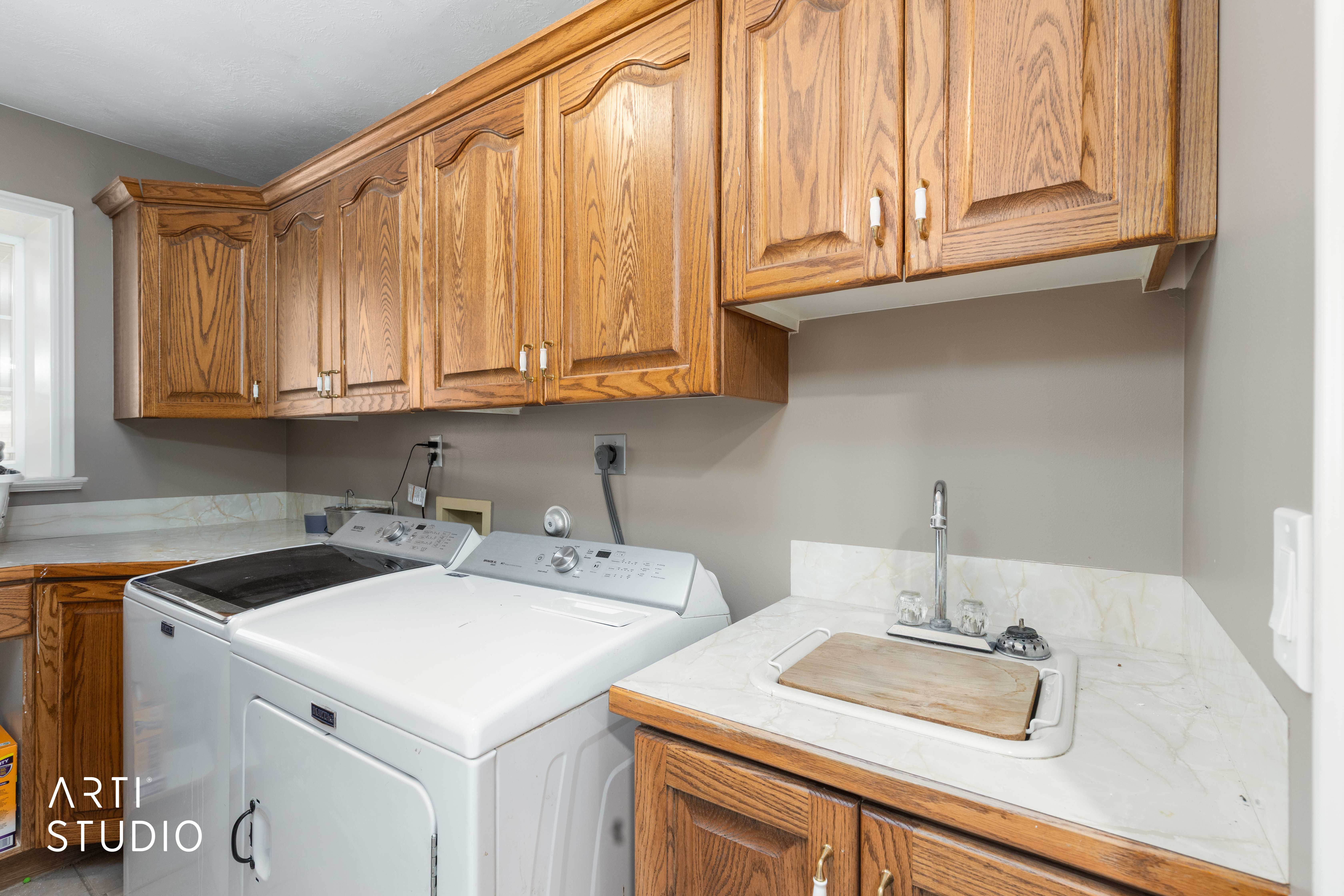 Laundry room featuring washing machine and clothes dryer and cabinet space