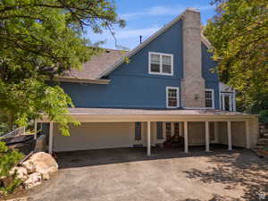 Blue stucco exterior with a prominent brick chimney