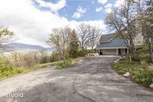View of asphalt driveway with a mountain view