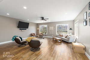 Living room with wood-type flooring, ceiling fan, and recessed lighting