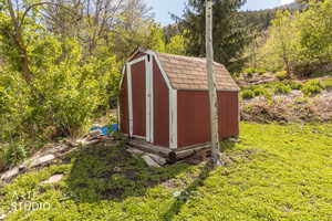 View of shed with a forest view