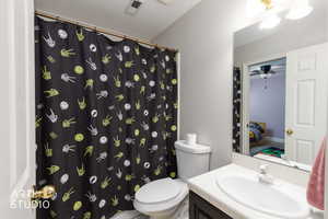 Bathroom with vanity, curtained shower, ceiling fan, and ensuite bathroom