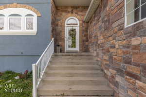 View of exterior entry with stone siding