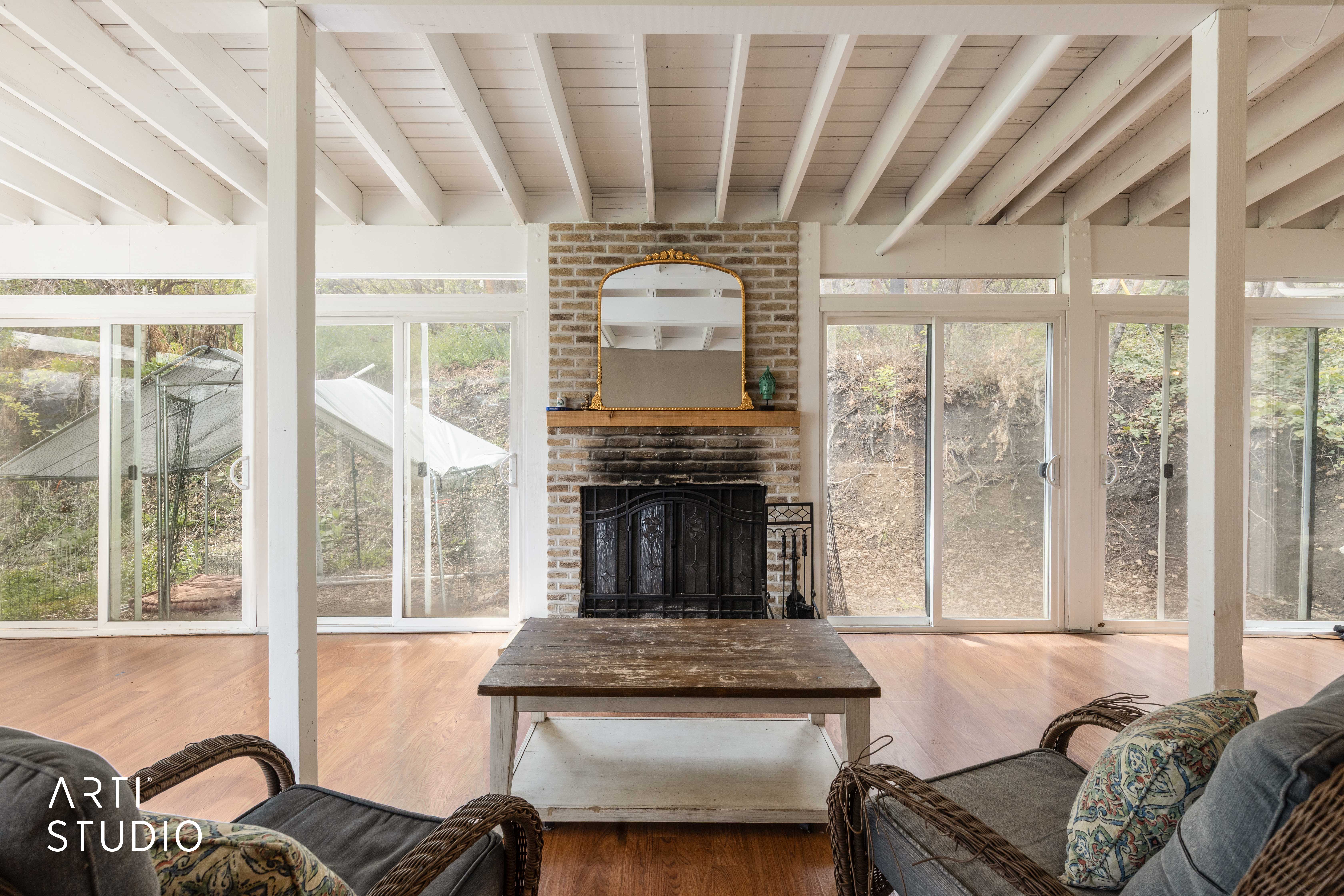 Sunroom / solarium featuring beamed ceiling and healthy amount of natural light