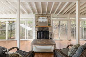 Sunroom / solarium featuring beamed ceiling and healthy amount of natural light