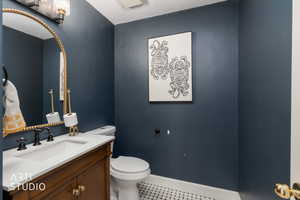 Half bath featuring vanity and toilet