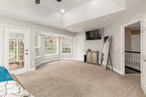Unfurnished living room featuring light colored carpet, a ceiling fan, and recessed lighting