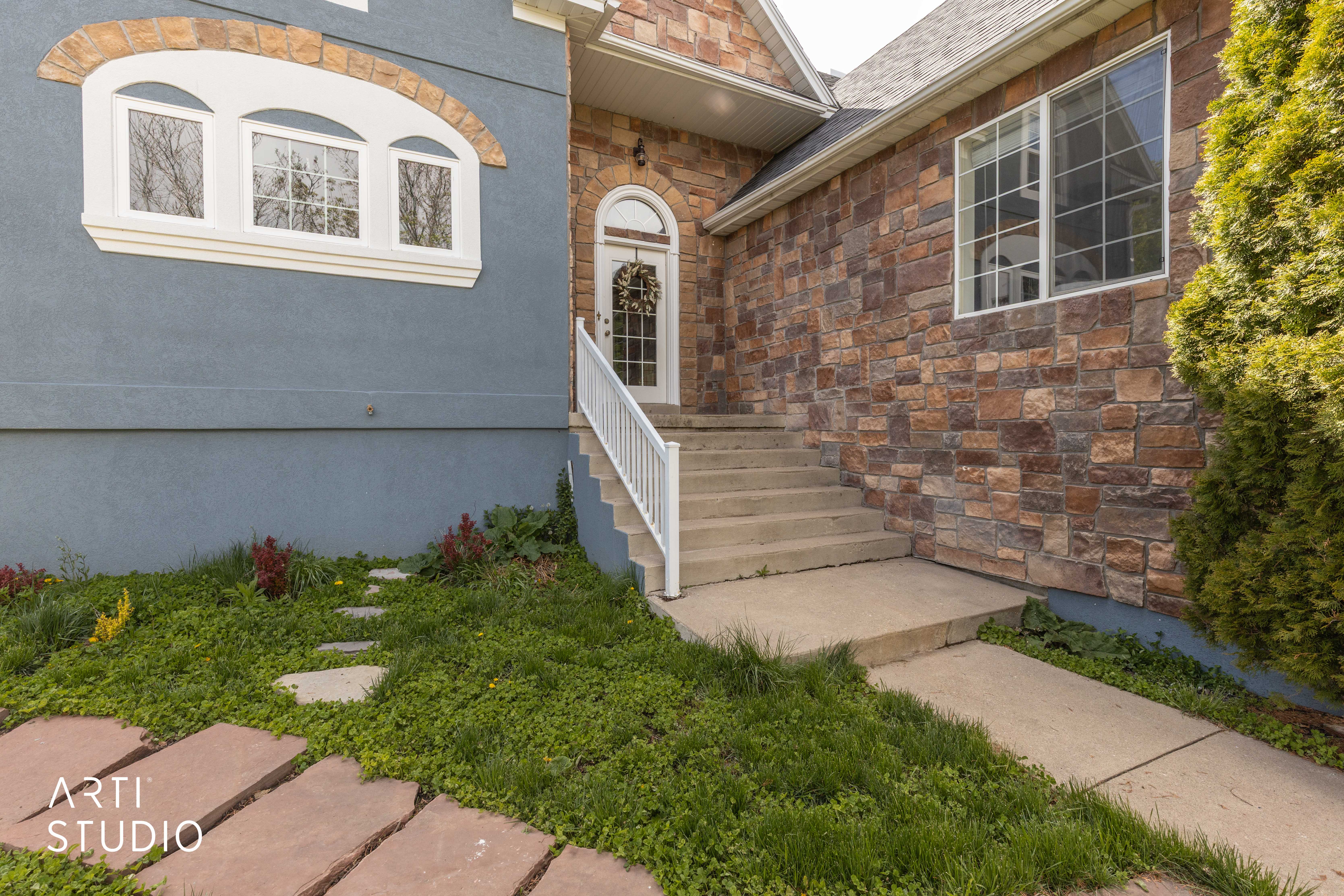 View of exterior entry featuring stone siding