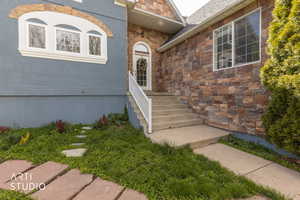 View of exterior entry featuring stone siding