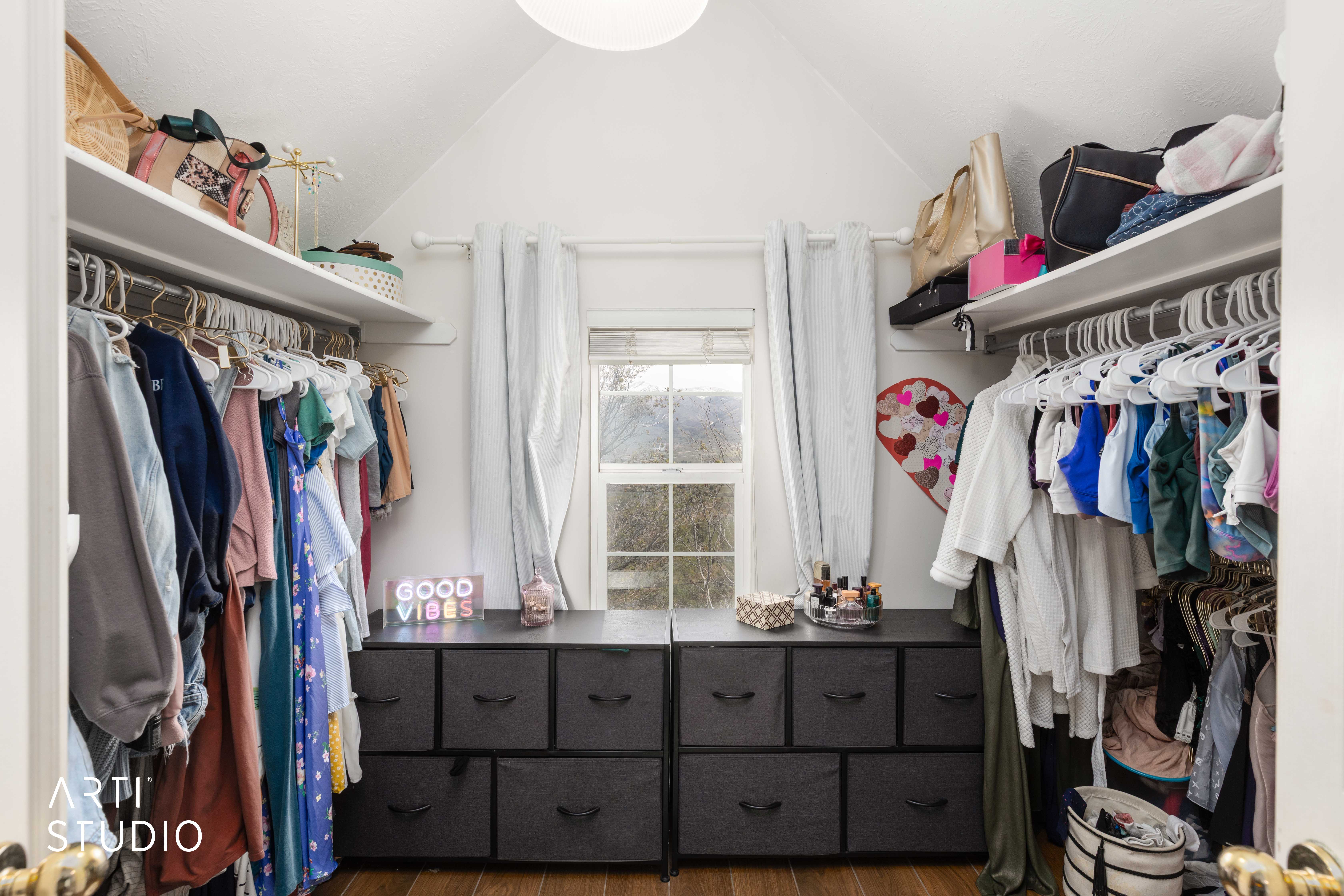 Walk in closet featuring dark wood finished floors