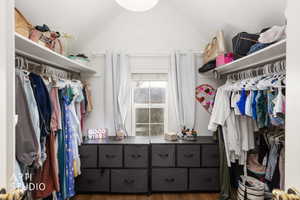 Walk in closet featuring dark wood finished floors