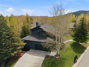 Aerial view of property and surrounding area with a mountainous background