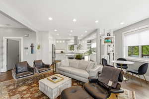 Living area with wood flooring and recessed lighting