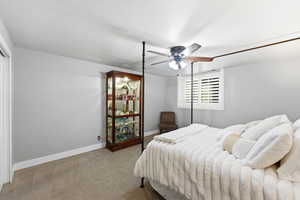 Bedroom featuring light colored carpet and ceiling fan
