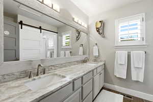 Bathroom with double vanity, healthy amount of natural light serving the 2 upstairs bedrooms