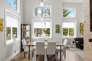 Dining room with hardwood flooring and a high ceiling
