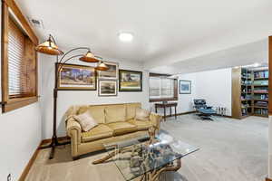 Living room with light carpet and baseboards
