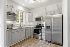 Mother in Law that can or can be a great office space or just additional living space. Kitchen featuring stainless steel appliances, ceiling fan, bedroom, bathroom and private entrance.