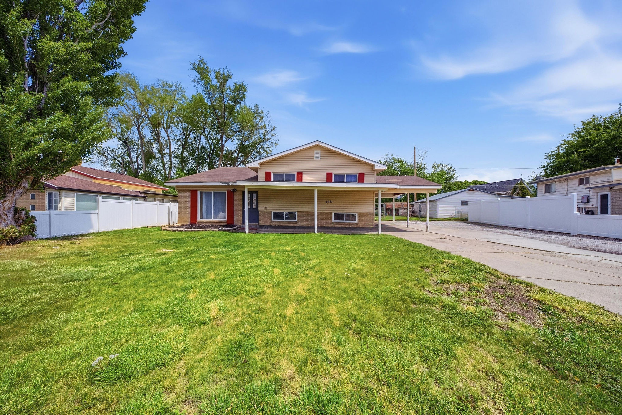 Back of property with covered porch and brick siding
