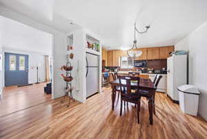 Dining room featuring light wood finished floors and baseboards