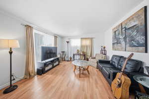 Living room with light wood finished floors and a textured ceiling